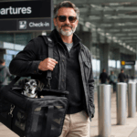 Experienced dog traveler with comfortable dog carrier showing travel readiness