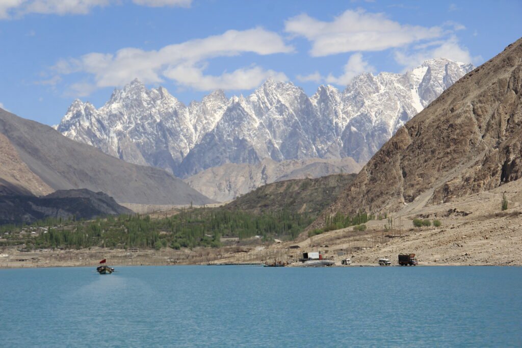 A boat on the turquoise water of Attabad Lake beneath the mountains of Gojal