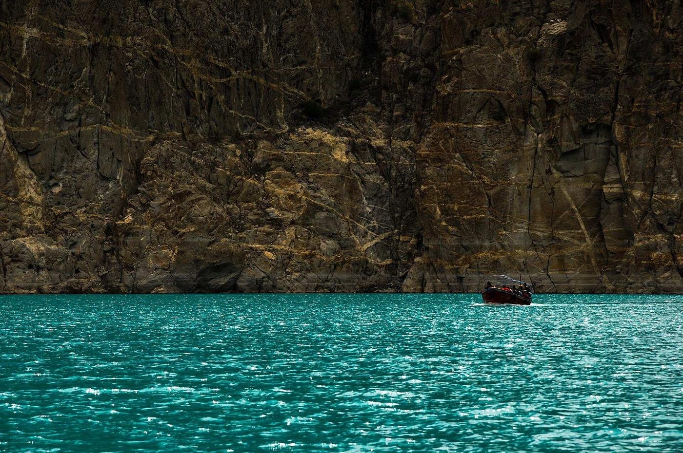 Boats on the turquoise water of Attabad Lake in Gojal, a highlight of visiting Hunza Valley in summer