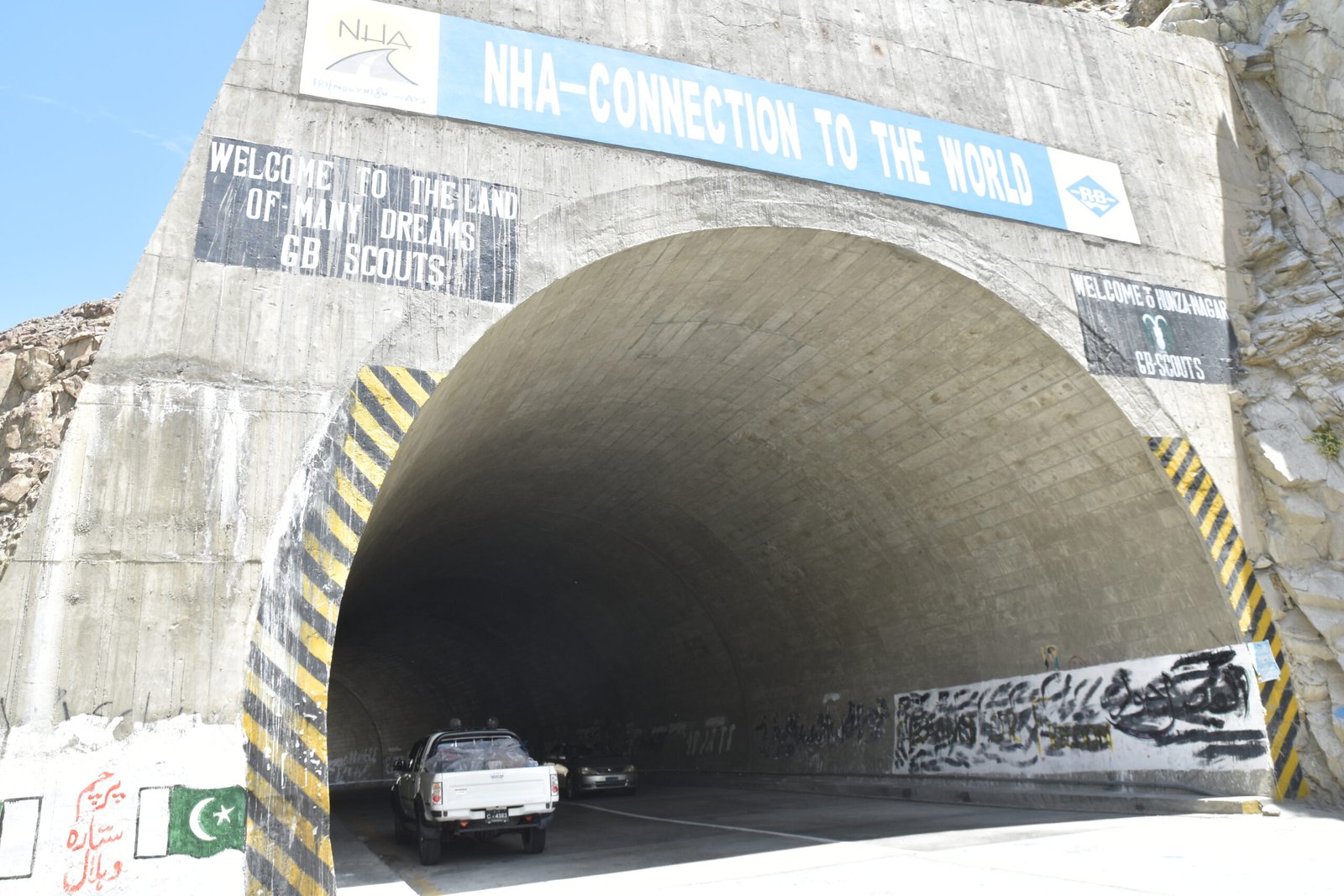 Karakoram Highway tunnel portal at Attabad Lake with a vehicle exiting