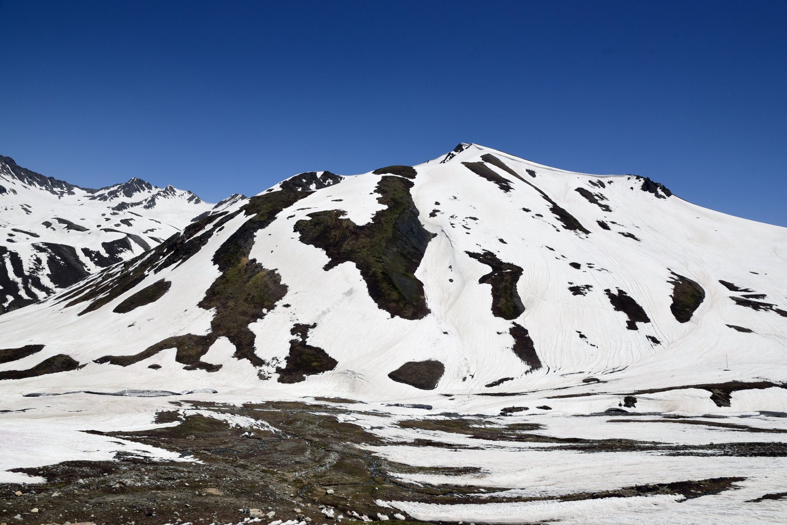 Snow-covered slopes of Burzil Pass above Astore Valley.