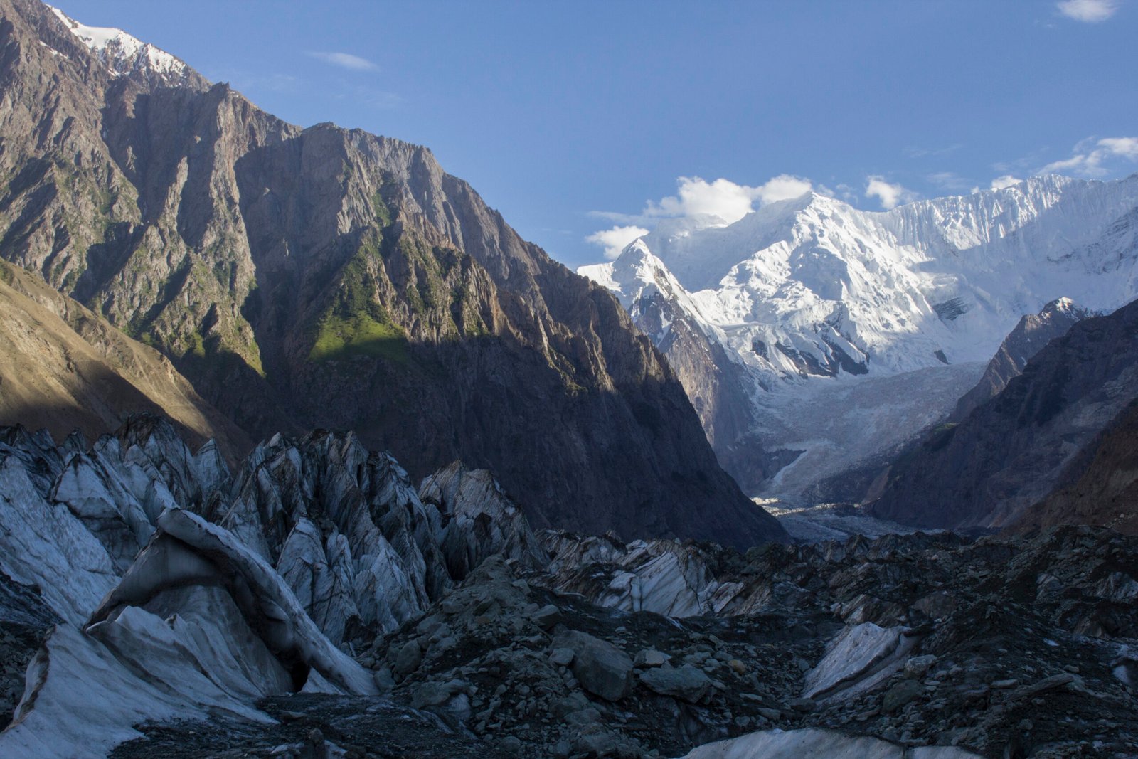 Debris-covered ice of the Hoper Glacier below snow peaks in Nagar Valley.