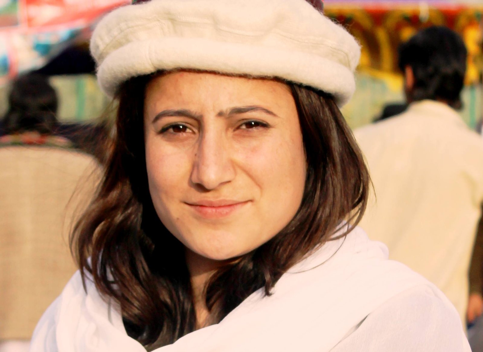 A woman wearing a white woollen traditional cap.