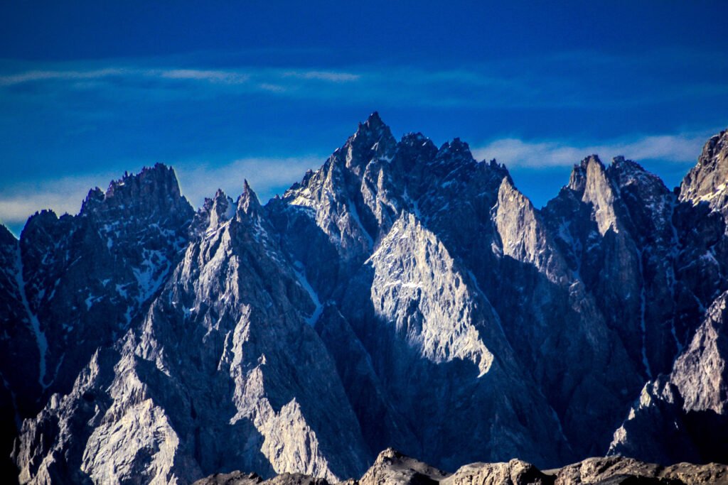 Passu Cones peaks rising above Passu village in Gojal, Hunza Valley