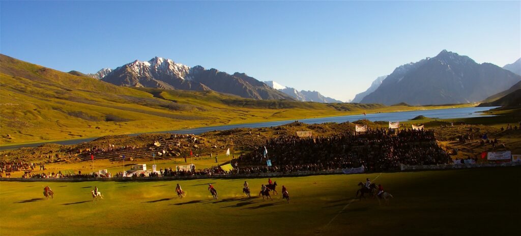 Freestyle polo match at the Shandur polo ground with Shandur Lake and mountains behind