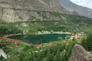 Shangrila Lake with resort buildings and mountains behind in Skardu