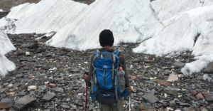 Trekker walking on the Baltoro Glacier moraine